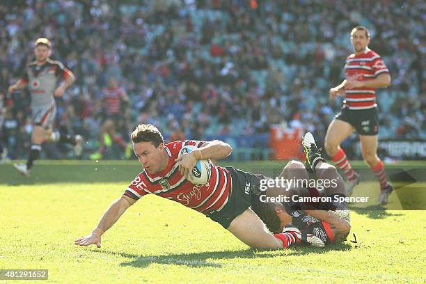 James Maloney of the Roosters scores a try during the round 19 NRL match between the Sydney Roosters and the New Zealand Warriors at Allianz Stadium...