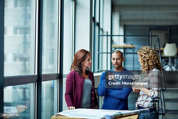 casual discussion between coworkers - partnership teamwork fotografías e imágenes de stock