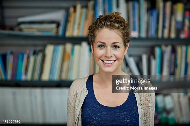 portrait of young architect - bücherwand stock-fotos und bilder