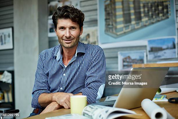 portrait of architect at workstation - architect stock pictures, royalty-free photos & images
