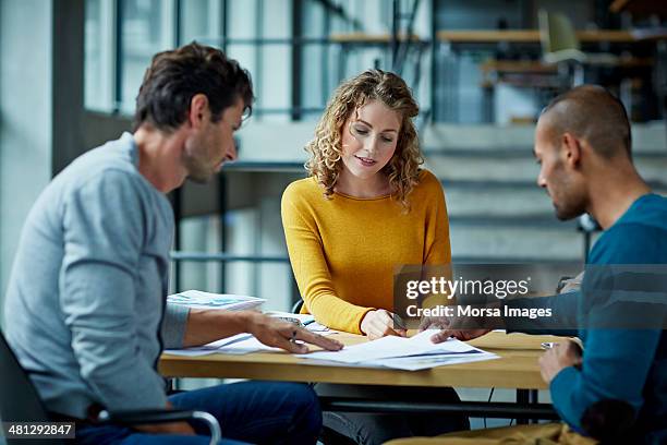 coworkers working on project - paperwork - fotografias e filmes do acervo