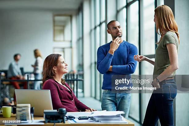 casual discussion between coworkers - rotterdam netherlands stock pictures, royalty-free photos & images