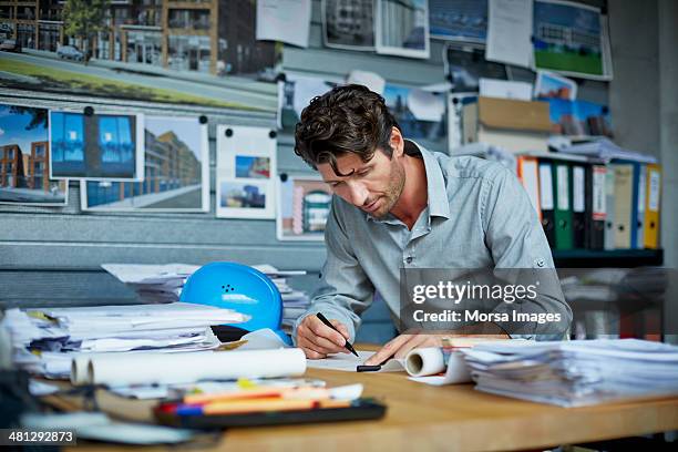 male architect working on project - architect sketching stock-fotos und bilder