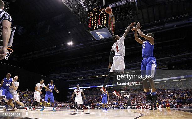 Kentucky Wildcats guard Aaron Harrison nails this 3-pointer with less than a minute to go in the game to give Kentucky a 2-point lead over Louisville...