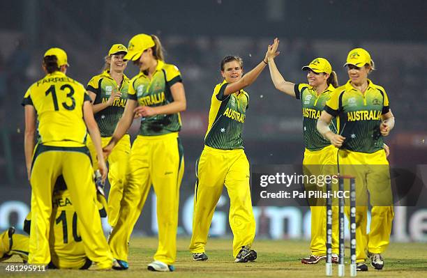 Jess Jonassen of Australia celebrates the wicket of Asmavia Iqbal of Pakistan during the ICC Women's world twenty20 match between Australia Women and...