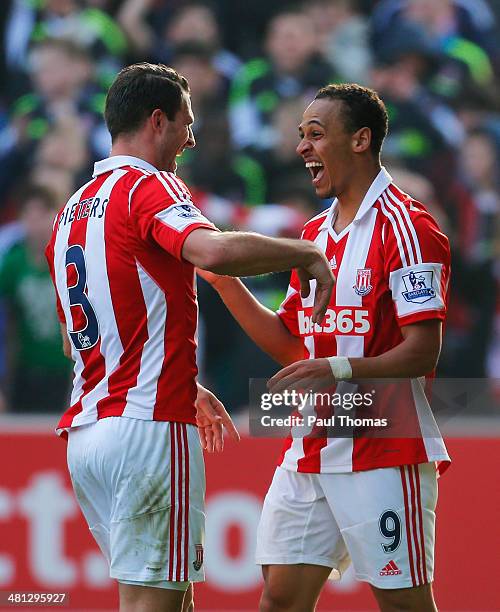 Peter Odemwingie of Stoke City celebrates his goal with Erik Pieters of Stoke City during the Barclays Premier League match between Stoke City and...