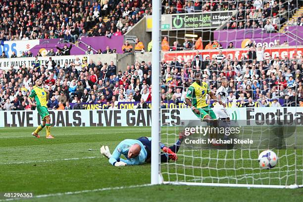 Wayne Routledge of Swansea City peels away after scoring his sides third goal as goalkeeperJohn Ruddy of Norwich City is beaten during the Barclays...