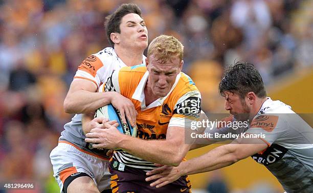 Jack Reed of the Broncos takes on the defence during the round 19 NRL match between the Brisbane Broncos and the Wests Tigers at Suncorp Stadium on...