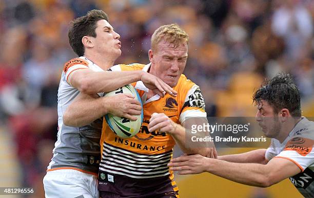 Jack Reed of the Broncos takes on the defence during the round 19 NRL match between the Brisbane Broncos and the Wests Tigers at Suncorp Stadium on...