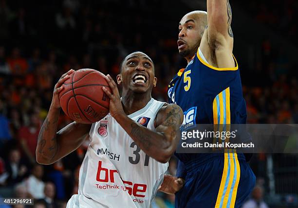 Jamar Smith of Bamberg is challenged by David Logan of Berlin during the Beko BBL Top Four semifinal match between Alba Berlin and Brose Baskets at...