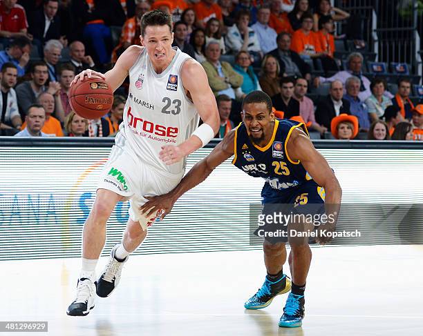 Casey Jacobsen of Bamberg is challenged by Clifford Hammonds of Berlin during the Beko BBL Top Four semifinal match between Alba Berlin and Brose...