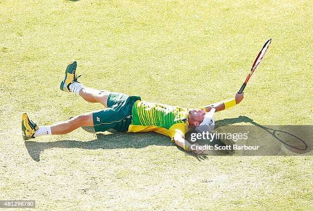 Lleyton Hewitt of Australia falls to the ground as he celebrates winning the reverse singles match between Lleyton Hewitt of Australia and Aleksandr...