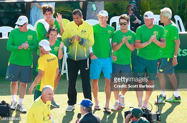 The Australian team including Sam Groth, Thanasi Kokkinakis and Nick Kyrgios applaud as teammate Lleyton Hewitt of Australia leaves the court after...