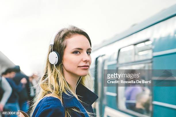 beautiful woman listening music on her smartphone, subway train background - walkman closeup stock pictures, royalty-free photos & images