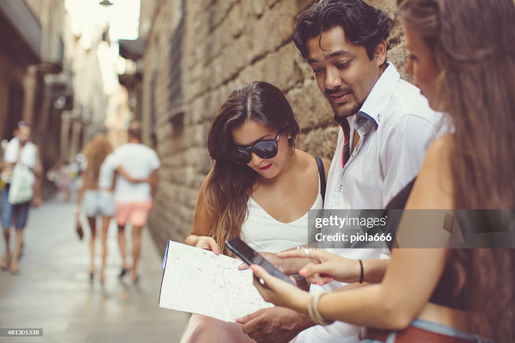 Tourists in Barcelona with a map