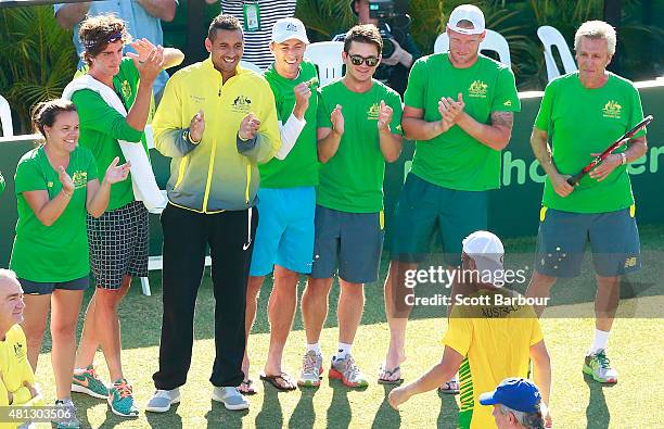 The Australian team including Sam Groth, Thanasi Kokkinakis and Nick Kyrgios applaud as teammate Lleyton Hewitt of Australia leaves the court after...