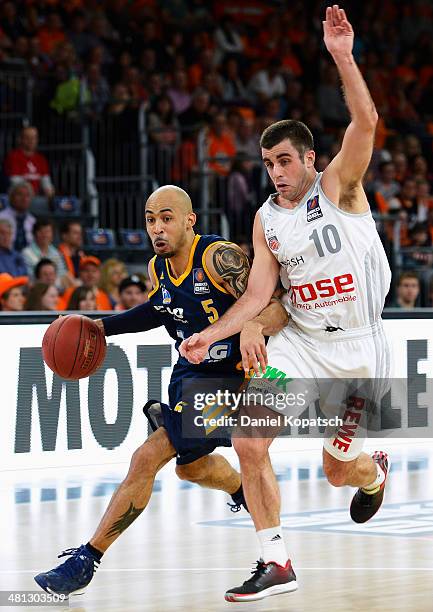 David Logan of Berlin is challenged by Jared Jordan of Bamberg during the Beko BBL Top Four semifinal match between Alba Berlin and Brose Baskets at...