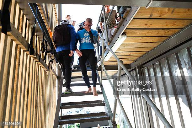 Mick Fanning of Australia reacts after he was attacked by a shark during the final of the JBay Open and explains to Kelly Slater of the United States...