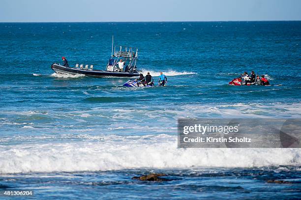 Mick Fanning and Julian Wilson both of Australia safely on the jetskis after Fanning was attacked by a shark at the JBay Open on July 19, 2015 in...
