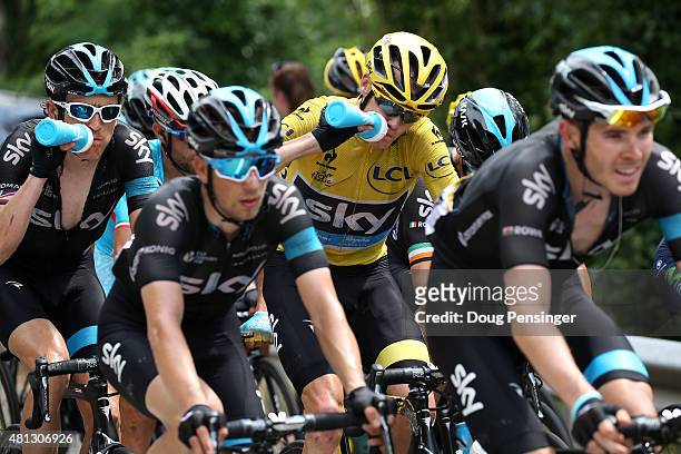 Chris Froome of Great Britain riding for Team Sky in the overall race leader yellow jersey takes a drink along with teammate Geraint Thomas of Great...