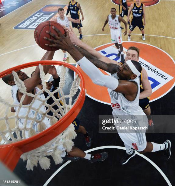 Or Fischer of Bamberg and Sharrod Ford of Bamberg block during the Beko BBL Top Four semifinal match between Alba Berlin and Brose Baskets at...