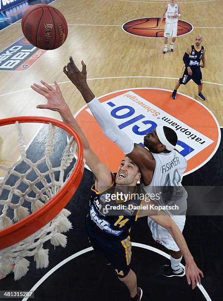 Levon Kendall of Berlin is challenged by D'Or Fischer of Bamberg during the Beko BBL Top Four semifinal match between Alba Berlin and Brose Baskets...
