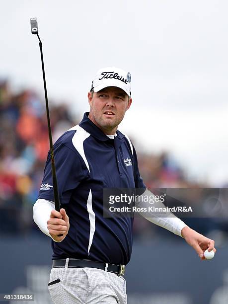 Marc Leishman of Australia acknowledges the crowd after holing his par putt on the 17th green during the third round of the 144th Open Championship...