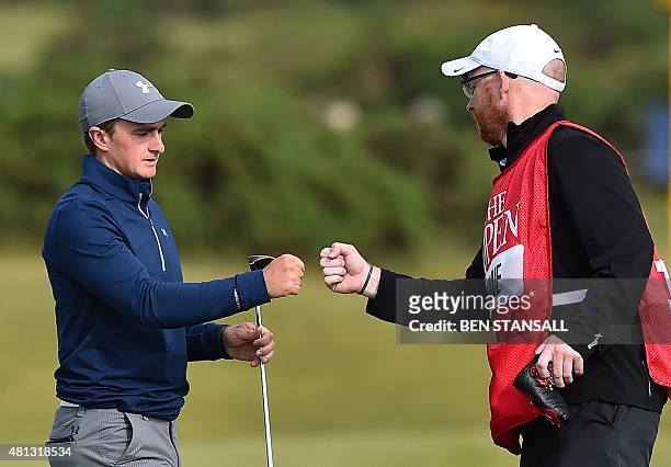 Ireland's amateur golfer Paul Dunne fist bumps his caddie Alan Murray on the 14th green during his third round 66, on day four of the 2015 British...