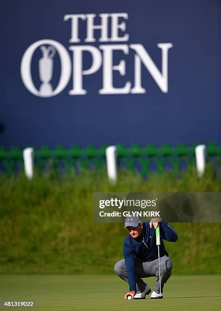 Ireland's amateur golfer Paul Dunne places his ball on the 18th green during his third round 66, on day four of the 2015 British Open Golf...