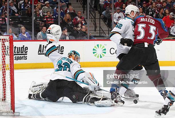 Goaltender Alex Stalock of the San Jose Sharks makes a save as teammate Matt Irwin defends against Cody McLeod of the Colorado Avalanche at the Pepsi...