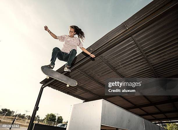 female skateboarder jumping - skater girl stock pictures, royalty-free photos & images