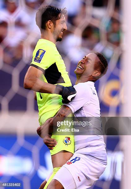 Gabriel Torres of Panama lifts teammate Jaime Penedo after they defeated Trinidad & Tobago in an overtime shootout during the quarterfinals of the...