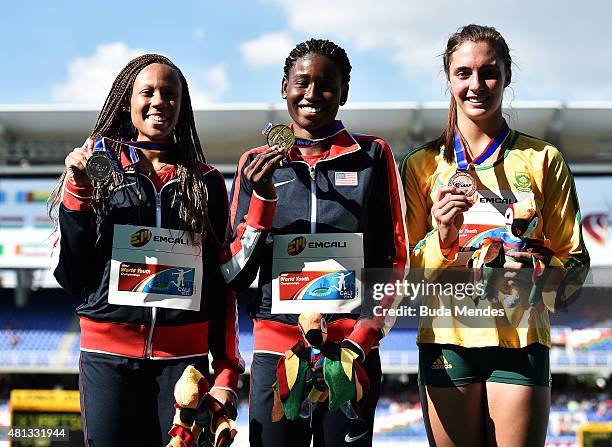 Candace Hill of the USA, gold medal, Lauren Rain Williams of the USA, silver medal, and Nicola De Bruyn of South Africa celebrate on the podium after...