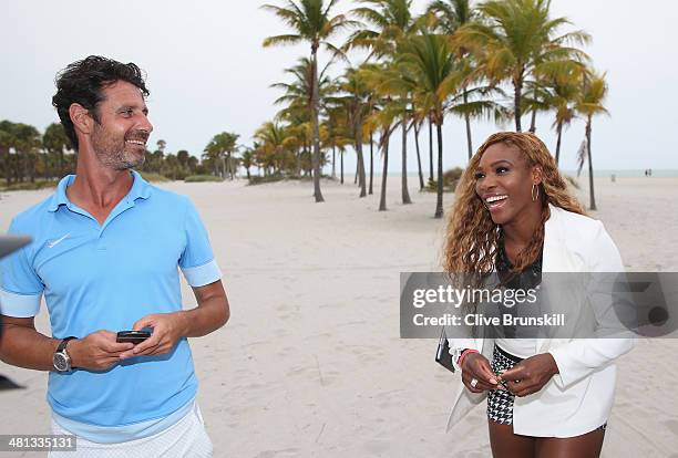 Serena Williams of the United States walks on Crandon Park beach and smiles to her coach and boyfriend Patrick Mouratoglou after her straight sets...