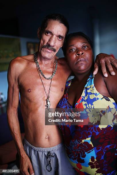 Louis Carlos de Sousa and Tania Gonzalves pose in their home in the unpacified Complexo da Mare slum complex, one of the largest 'favela' complexes...