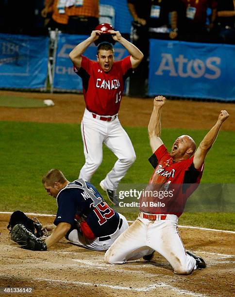 Peter Orr of Canada celebrates scoring the winning run in the tenth inning as Thomas Murphy of the USA and Tyler O'Neill of Canada looks after their...