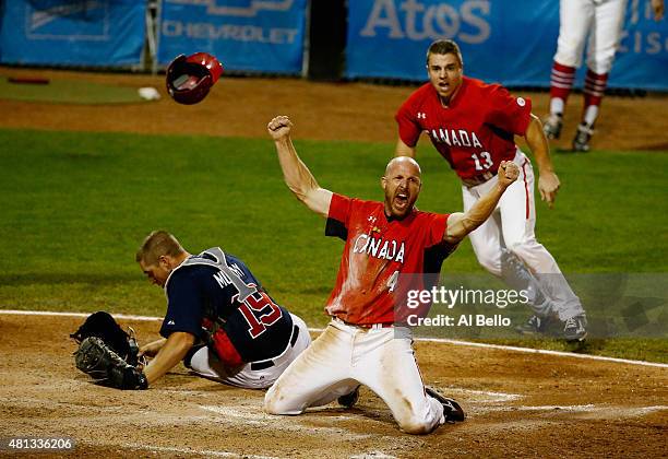 Peter Orr of Canada celebrates scoring the winning run in the tenth inning as Thomas Murphy of the USA and Tyler O'Neill of Canada looks after their...