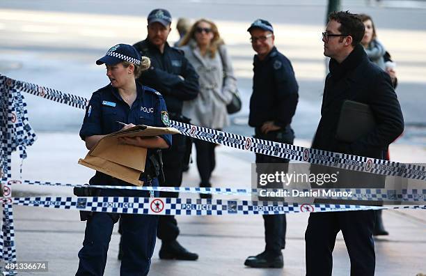 Police officer works at the Australian Federal Police headquarters cordoned with police tape due to a suspicious package on July 20, 2015 in Sydney,...