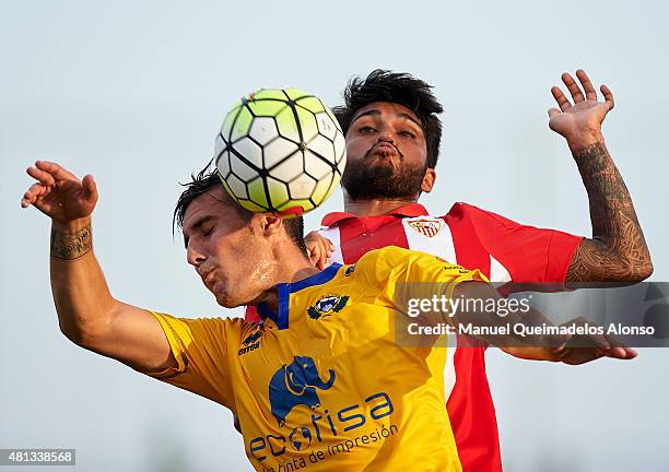 Benoit Tremoulinas of Sevilla battle for the ball with Sergio Guardiola of Alcorcon during a Pre Season Friendly match between Sevilla and Alcorcon...