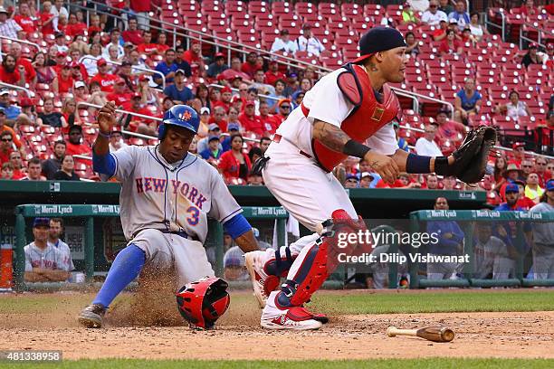 Curtis Granderson of the New York Mets scores a run against Yadier Molina of the St. Louis Cardinals in the 18th inning at Busch Stadium on July 19,...