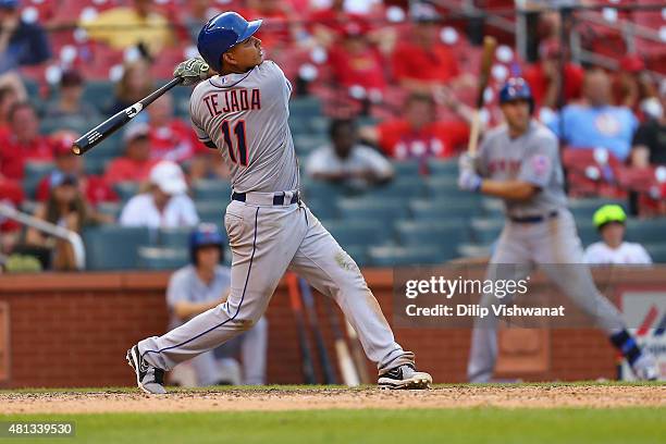 Ruben Tejada of the New York Mets hits a game-winning sacrifice RBI against the St. Louis Cardinals in the 18th inning at Busch Stadium on July 19,...