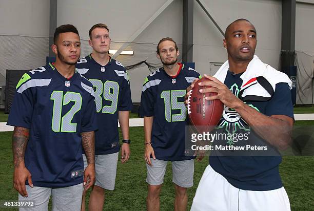Memphis Depay, Phil Jones and Daley Blind of Manchester United meet Doug Baldwin of the Seattle Seahawks at a Meet and Greet event during the club's...