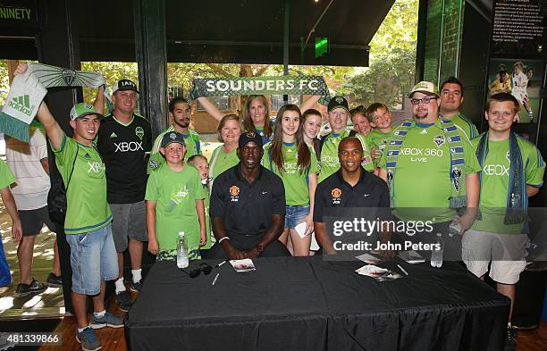 Former players Dwight Yorke and Quinton Fortune of Manchester United meet Seattle Sounders fans at a Meet and Greet event during the club's...