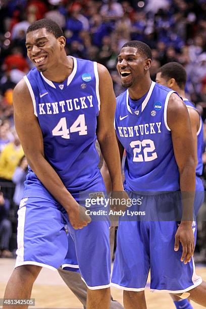 Dakari Johnson and Alex Poythress of the Kentucky Wildcats celebrate defeating the Louisville Cardinals 74 to 69 during the regional semifinal of the...