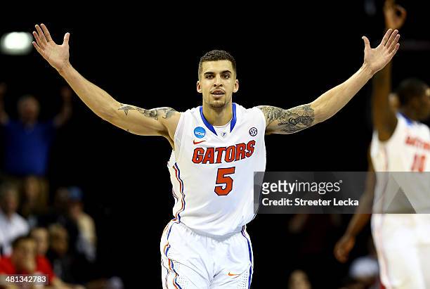 Scottie Wilbekin of the Florida Gators celebrates after hitting a three pointer to end the first half against the Dayton Flyers during the south...