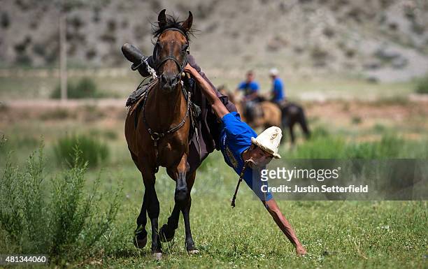 Competitors take part in the game of 'Tyin Enmei' which involves picking up coins from the ground while racing on horseback during the Kyrgyz...