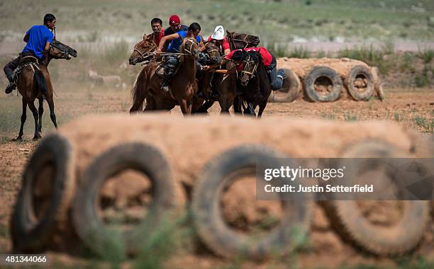 Competitors take part in a game of Kok Boru during the Kyrgyz national horse games on July 18, 2015 in kyzyl-Oi, Kyrgyzstan. The game Kok Boru...