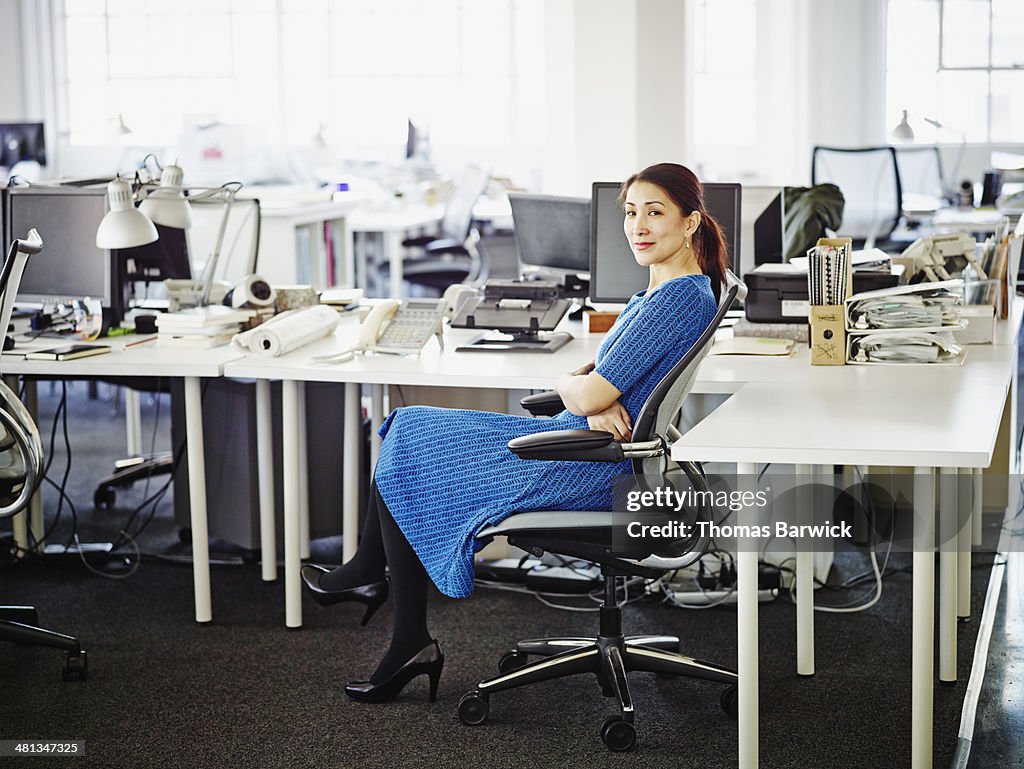 Smiling businesswoman sitting at workstation