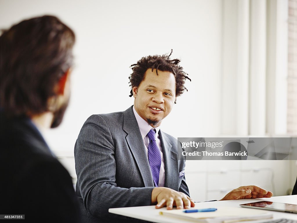 Coworker in discussion in conference room
