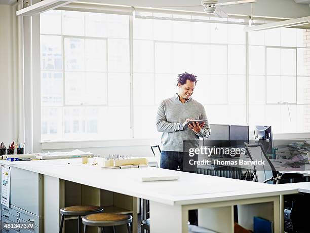 smiling businessman working on digital tablet - long sleeve t shirt stock pictures, royalty-free photos & images